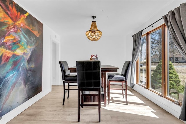 dining room with an inviting chandelier and wood finished floors