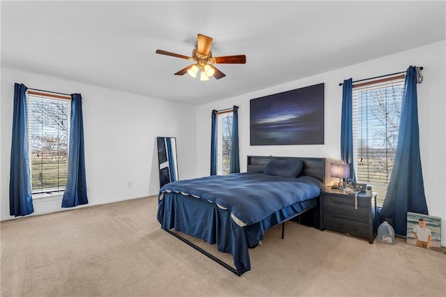 bedroom featuring carpet flooring, multiple windows, and ceiling fan