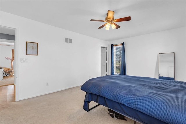 carpeted bedroom featuring visible vents, baseboards, and a ceiling fan