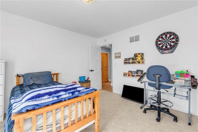 carpeted bedroom featuring visible vents and baseboards