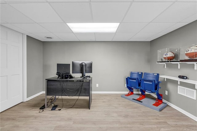 home office featuring wood finished floors, baseboards, and a paneled ceiling