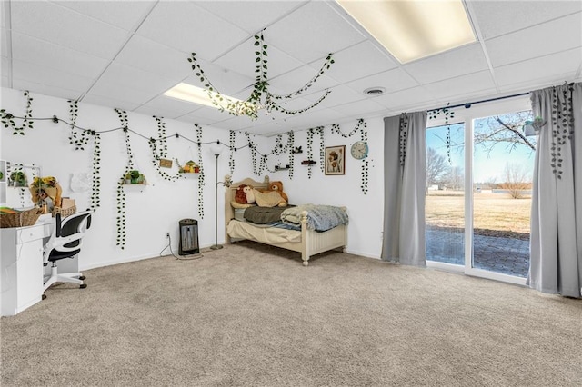 sitting room with visible vents, light colored carpet, and a paneled ceiling