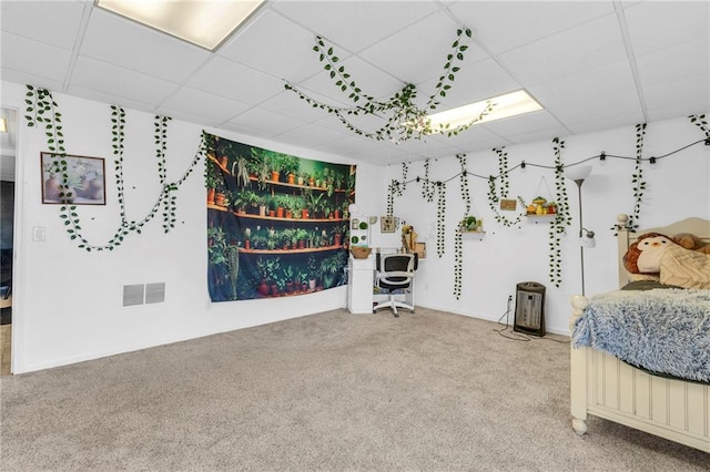 bedroom featuring a drop ceiling, visible vents, and carpet