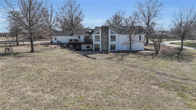 back of house with a deck