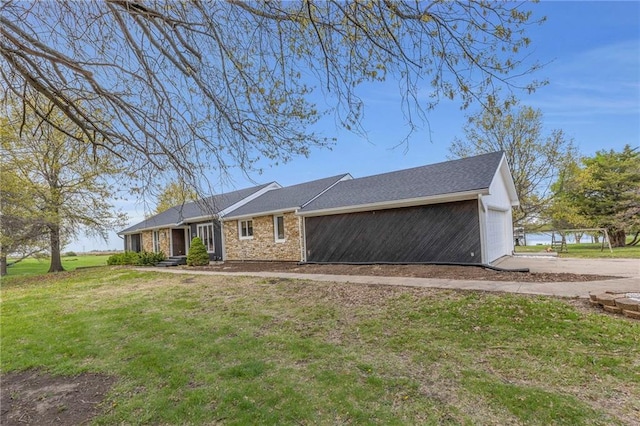 view of side of home featuring a lawn and a garage