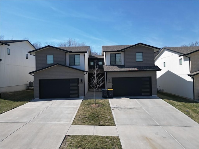 view of front of home featuring concrete driveway, an attached garage, central AC unit, and a shingled roof