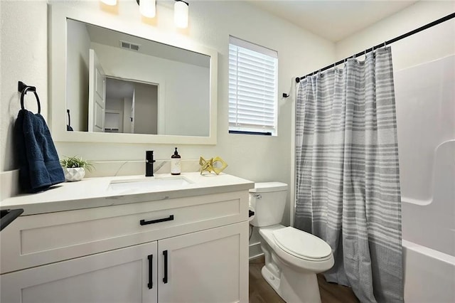 bathroom featuring vanity, shower / bath combination with curtain, toilet, and visible vents