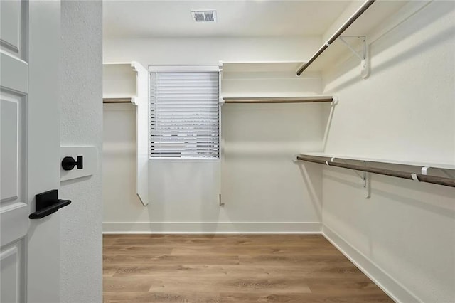 spacious closet with wood finished floors and visible vents