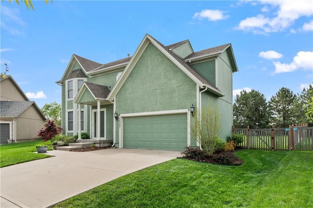 24987 W 150th Ct, Olathe, KS 66061 - view of front facade featuring an attached garage, stucco siding, fence, a front yard, and driveway