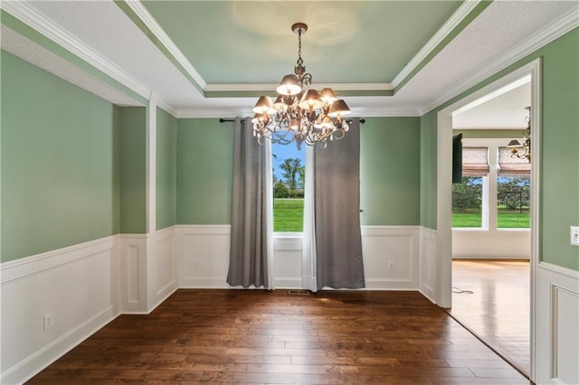 24987 W 150th Ct, Olathe, KS 66061 - unfurnished dining area featuring ornamental molding, wainscoting, wood-type flooring, a chandelier, and a raised ceiling