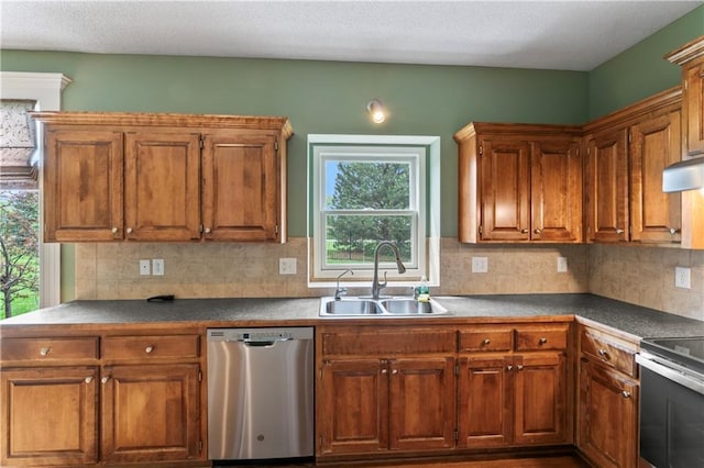 24987 W 150th Ct, Olathe, KS 66061 - kitchen featuring stainless steel appliances, brown cabinetry, tasteful backsplash, and a sink