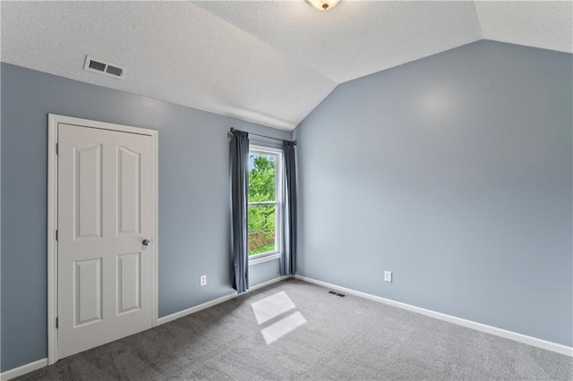 24987 W 150th Ct, Olathe, KS 66061 - carpeted spare room with a textured ceiling, vaulted ceiling, baseboards, and visible vents