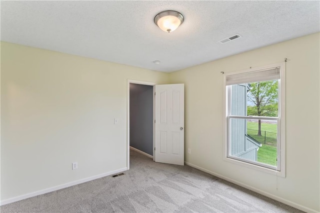 24987 W 150th Ct, Olathe, KS 66061 - empty room with light carpet, a textured ceiling, baseboards, and visible vents