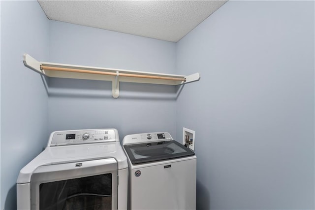 24987 W 150th Ct, Olathe, KS 66061 - laundry area with laundry area, a textured ceiling, and separate washer and dryer