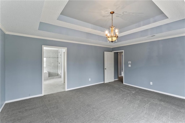 24987 W 150th Ct, Olathe, KS 66061 - spare room featuring a tray ceiling, a chandelier, carpet, and baseboards