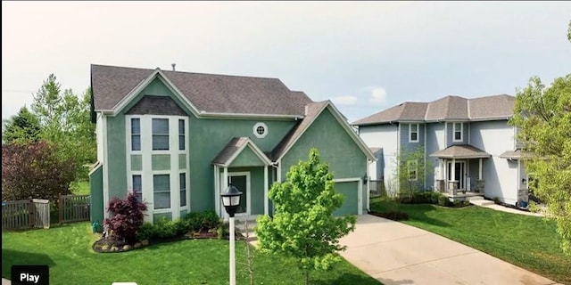 24987 W 150th Ct, Olathe, KS 66061 - view of front of property featuring an attached garage, stucco siding, fence, a front lawn, and driveway