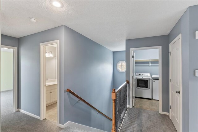 24987 W 150th Ct, Olathe, KS 66061 - hall with an upstairs landing, carpet flooring, washing machine and dryer, and a textured ceiling