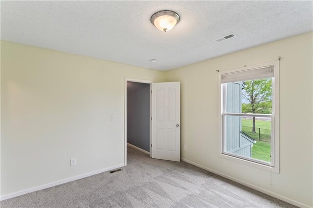 24987 W 150th Ct, Olathe, KS 66061 - empty room with light colored carpet, baseboards, and a textured ceiling