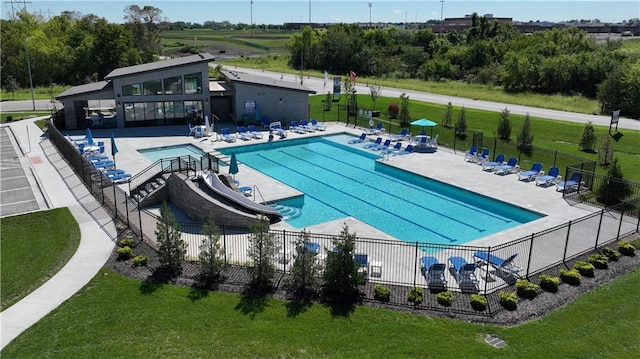 pool with a yard, a patio, and fence