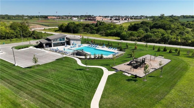 pool featuring a lawn, a patio, and fence