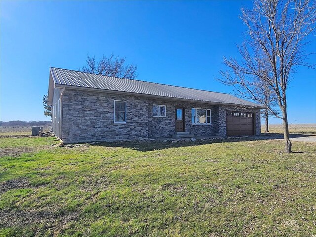 25237 NW Barton Rd, Westphalia, KS 66093 - single story home with central air condition unit, metal roof, a front lawn, and a garage