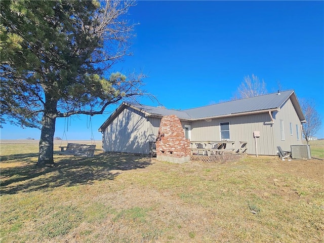 25237 NW Barton Rd, Westphalia, KS 66093 - view of property exterior featuring a yard, metal roof, and central air condition unit