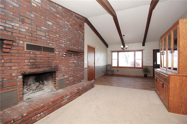 25237 NW Barton Rd, Westphalia, KS 66093 - unfurnished living room featuring visible vents, carpet, a brick fireplace, and vaulted ceiling with beams