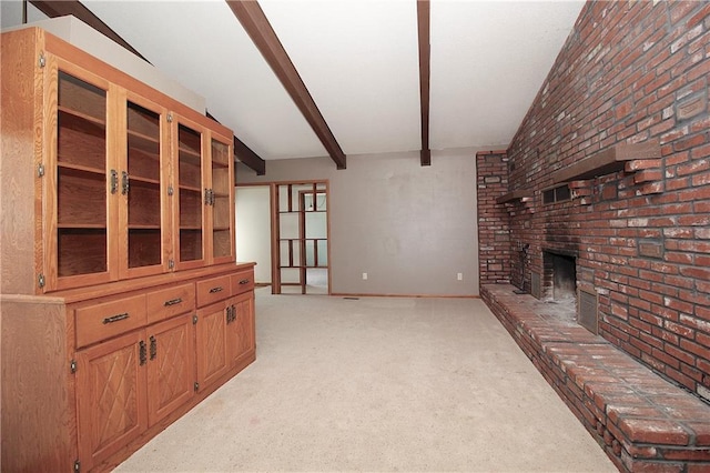 25237 NW Barton Rd, Westphalia, KS 66093 - unfurnished living room with light colored carpet, beam ceiling, a brick fireplace, brick wall, and baseboards