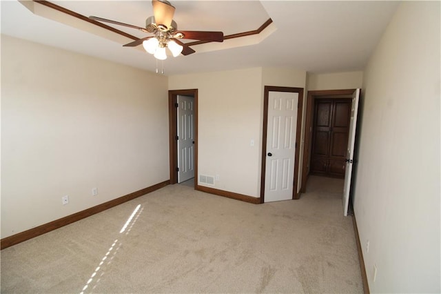 unfurnished bedroom featuring visible vents, baseboards, carpet, and a ceiling fan