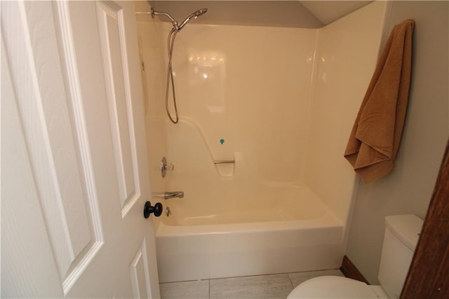 full bathroom featuring toilet, bathtub / shower combination, and tile patterned flooring