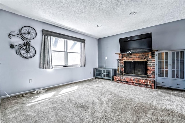 unfurnished living room featuring carpet, a fireplace, baseboards, and a textured ceiling