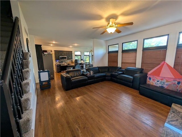 7730 N Shannon Ave, Kansas City, MO 64152 - living room with dark wood finished floors, a ceiling fan, and stairs