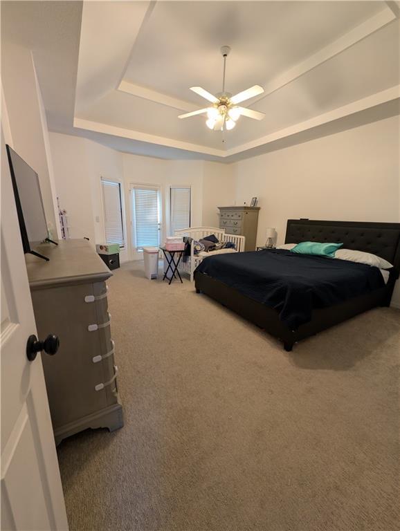 7730 N Shannon Ave, Kansas City, MO 64152 - bedroom featuring a raised ceiling, carpet floors, and ceiling fan