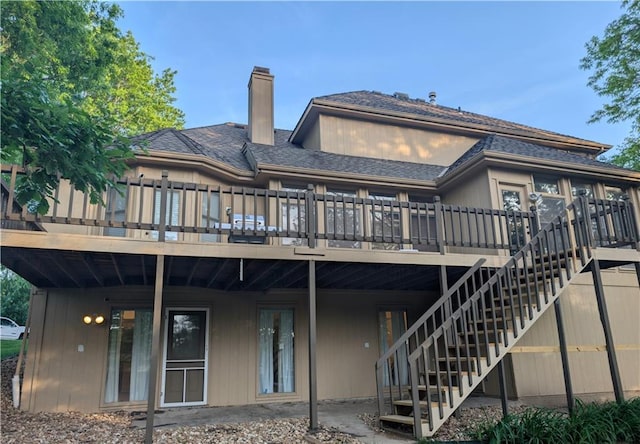 7730 N Shannon Ave, Kansas City, MO 64152 - back of house featuring a chimney, a wooden deck, and stairs