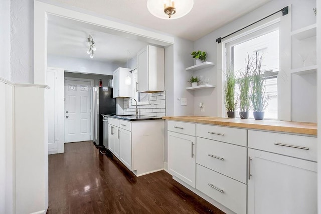 kitchen featuring tasteful backsplash, white cabinetry, dark wood-type flooring, and open shelves