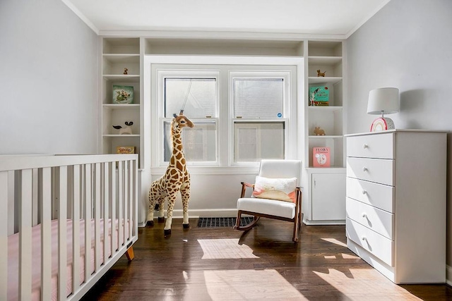 bedroom featuring wood finished floors, baseboards, and ornamental molding