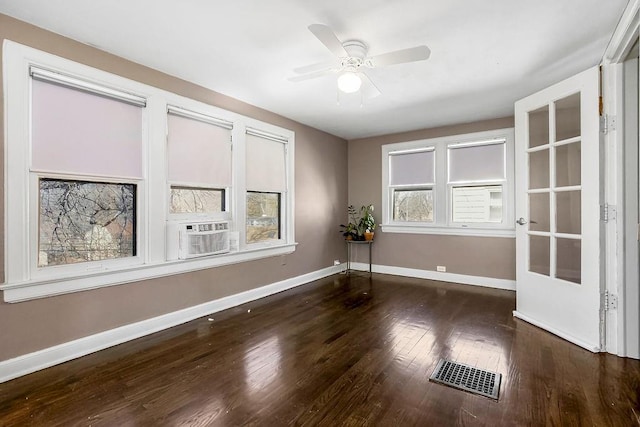 spare room with baseboards, visible vents, and a healthy amount of sunlight