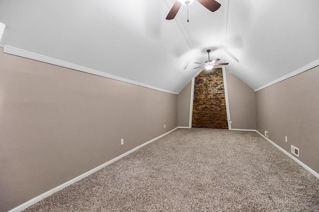 bonus room featuring lofted ceiling, carpet flooring, a ceiling fan, and baseboards