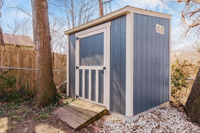 view of shed with fence