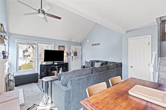 living area featuring visible vents, carpet, stairway, lofted ceiling with beams, and a textured ceiling