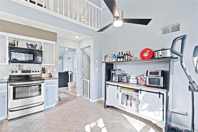 kitchen with visible vents, stainless steel electric stove, light tile patterned flooring, ceiling fan, and black microwave