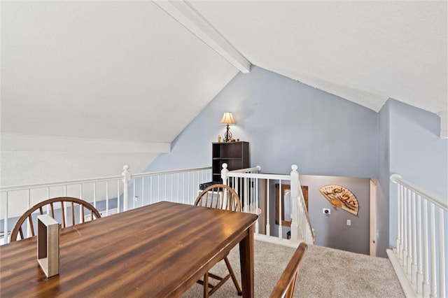 carpeted dining room featuring lofted ceiling with beams