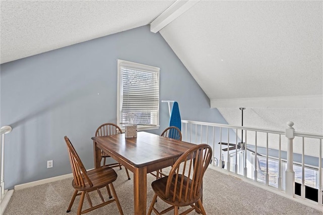 carpeted dining area featuring a textured ceiling, vaulted ceiling with beams, and baseboards