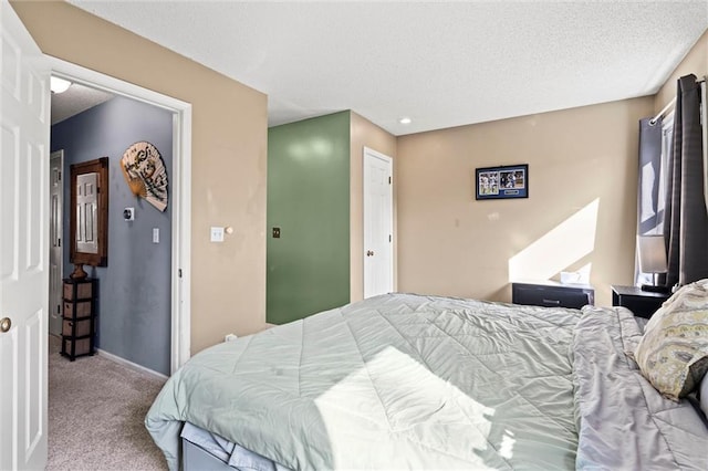 carpeted bedroom with a textured ceiling and baseboards