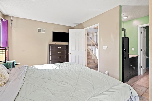 tiled bedroom featuring visible vents