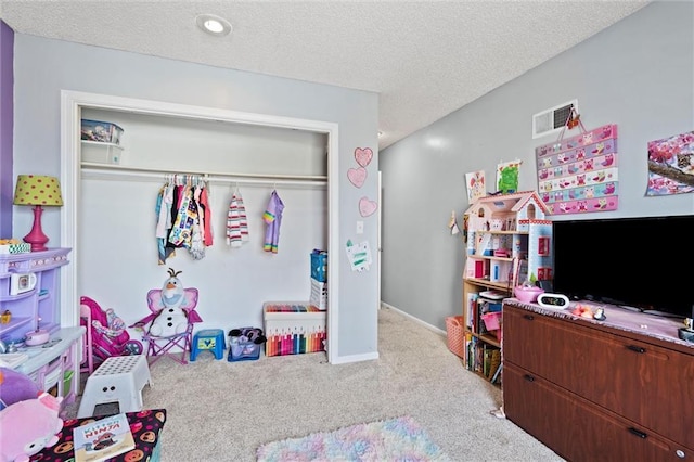 recreation room featuring visible vents, baseboards, a textured ceiling, and carpet flooring