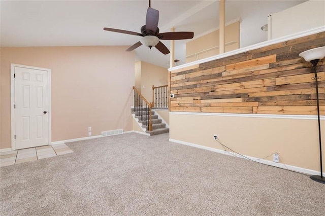 unfurnished living room featuring visible vents, baseboards, ceiling fan, vaulted ceiling, and carpet floors