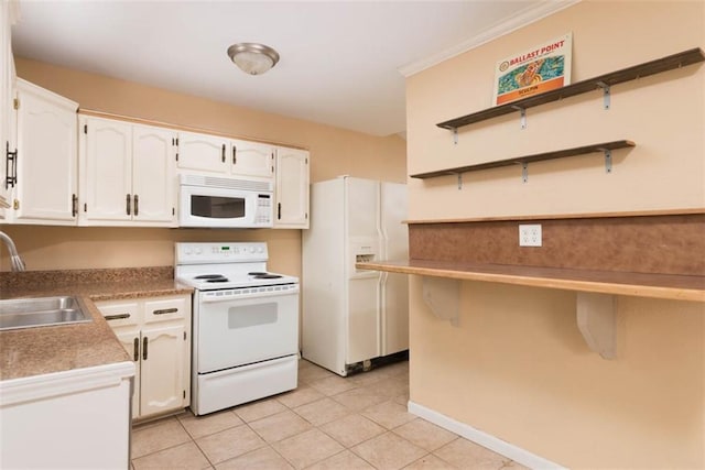 kitchen with white appliances, light tile patterned floors, open shelves, a sink, and white cabinetry