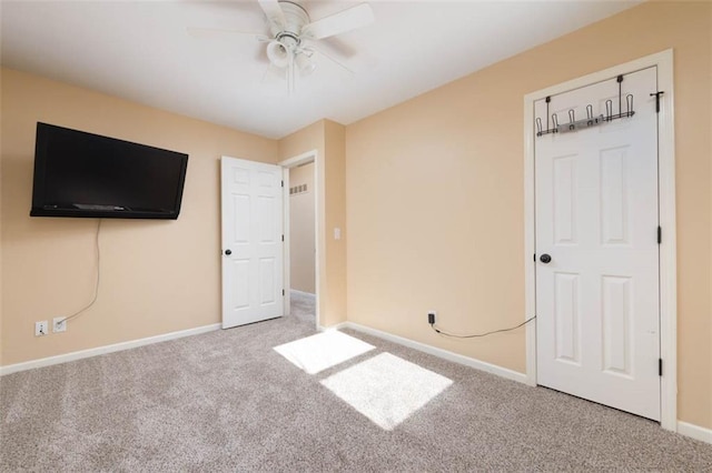 unfurnished bedroom with baseboards, a ceiling fan, and carpet flooring