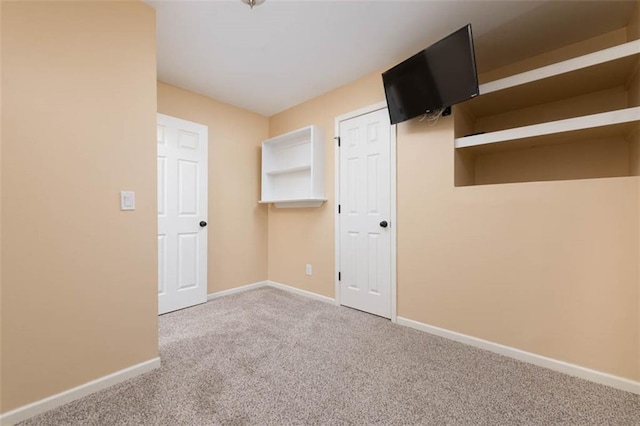 unfurnished bedroom featuring carpet flooring and baseboards